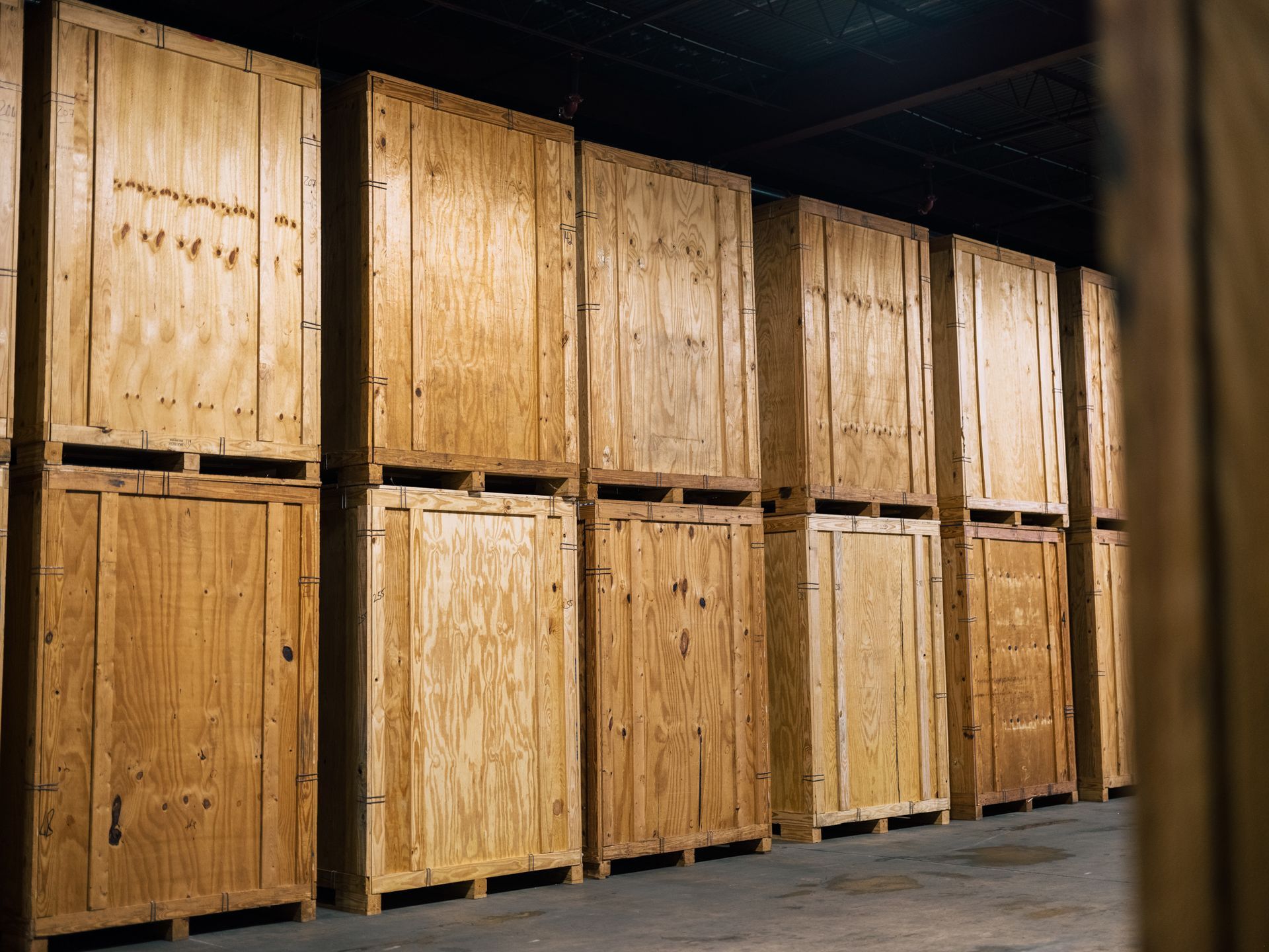 Rows of wooden storage units in a dimly lit warehouse.
