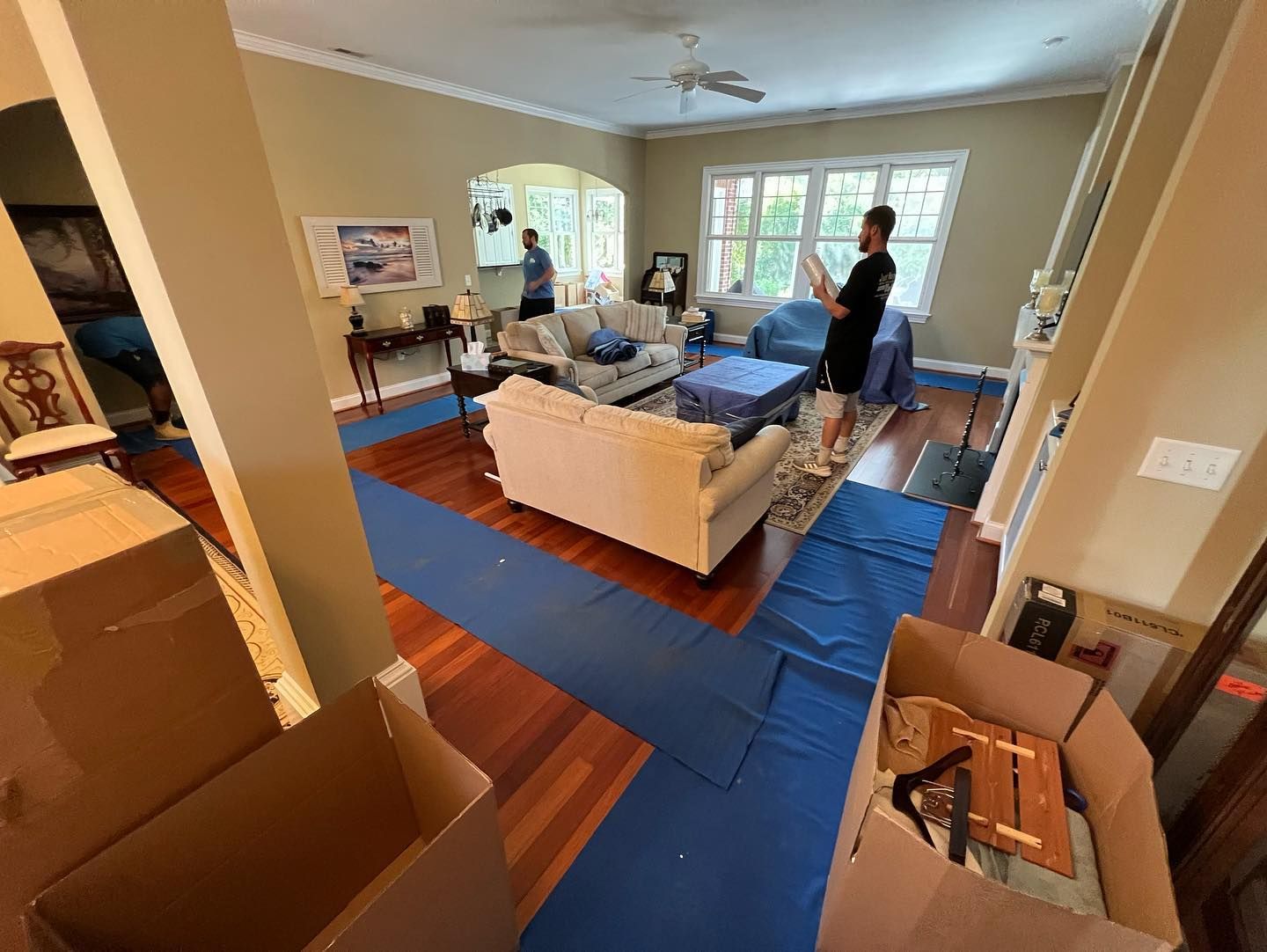 A living room filled with furniture and boxes.