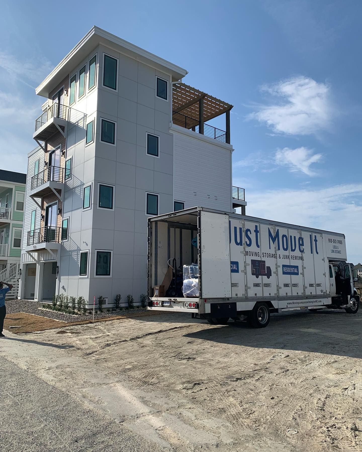 A just move truck is parked in front of a building