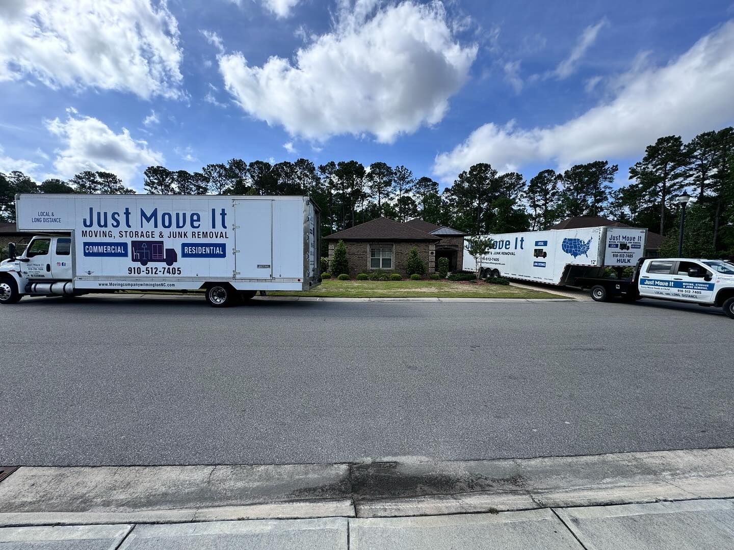 A just move it truck is parked on the side of the road.