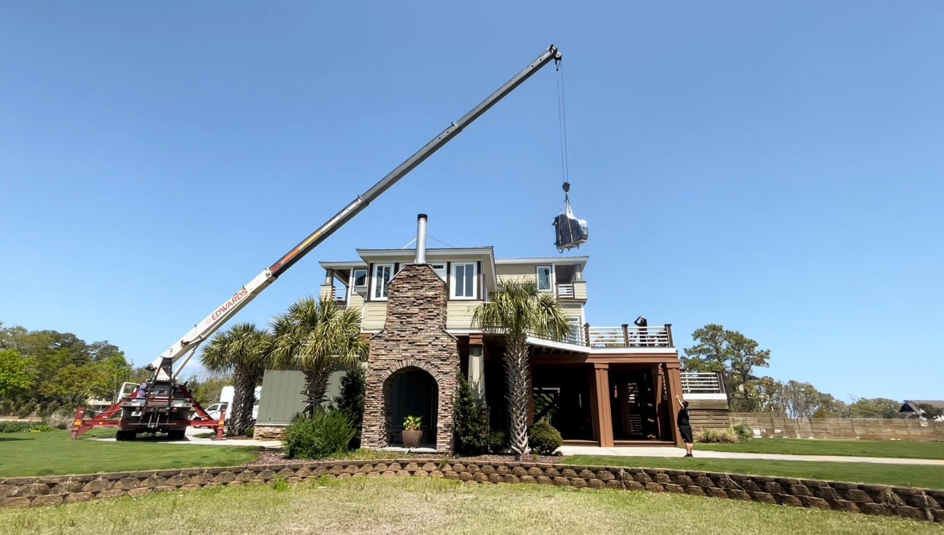 A large house with a crane in front of it