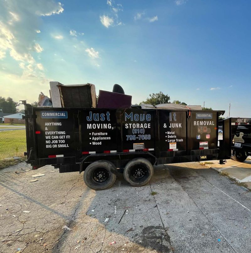 A junk removal trailer is parked on the side of the road.