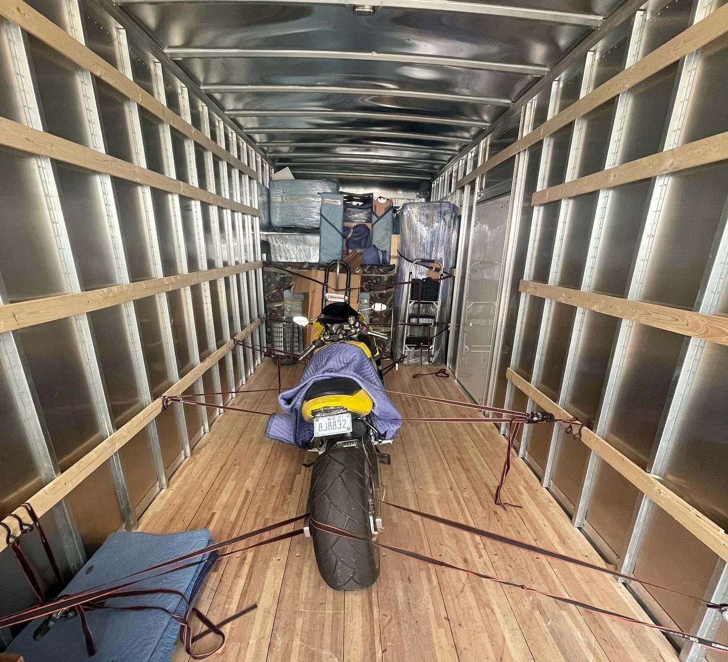A motorcycle is sitting in the back of a trailer.