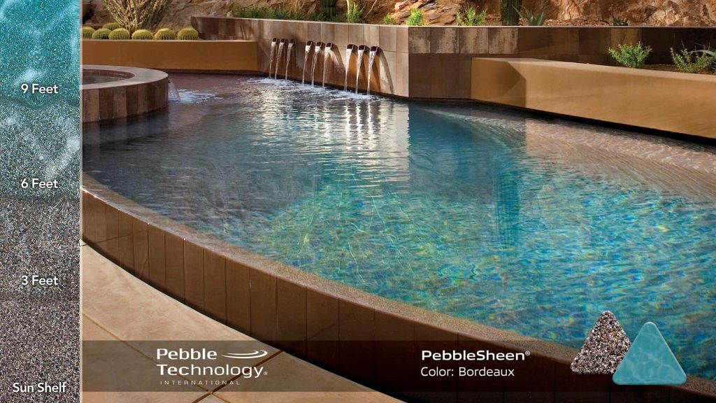 Swimming pool with stone walls, water fountains, and Pebble Technology logo.