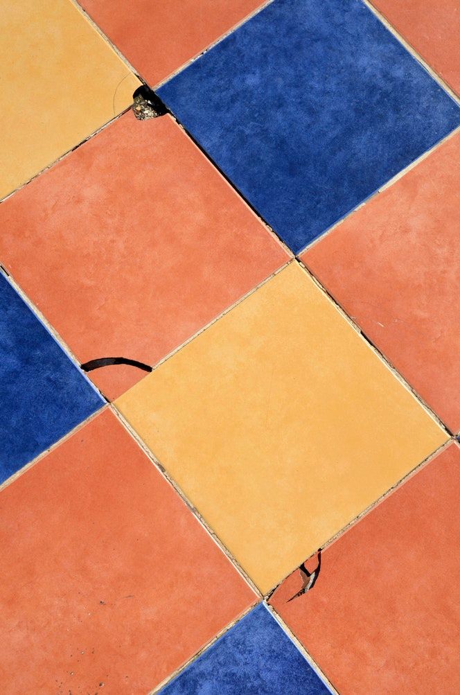 Diagonal tiled floor pattern; orange, yellow, and blue square tiles.