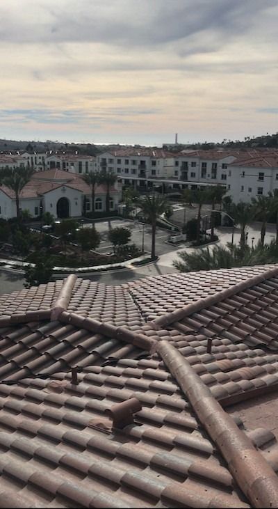An aerial view of a tiled roof with a city in the background.