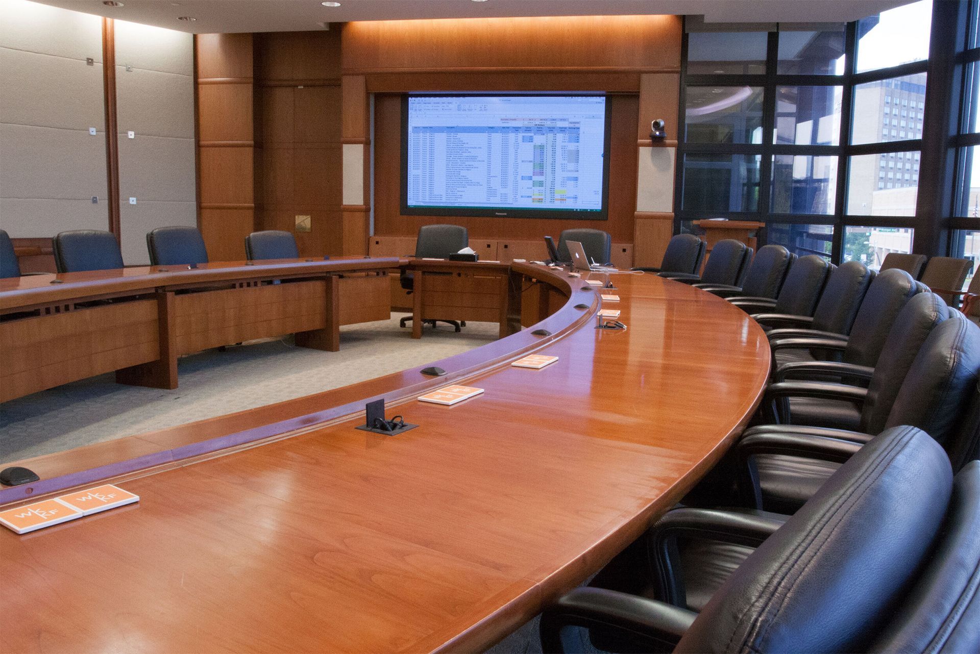A conference room with a long wooden table and chairs
