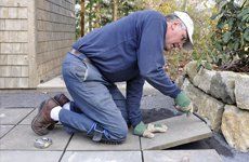 Worker installing a tile