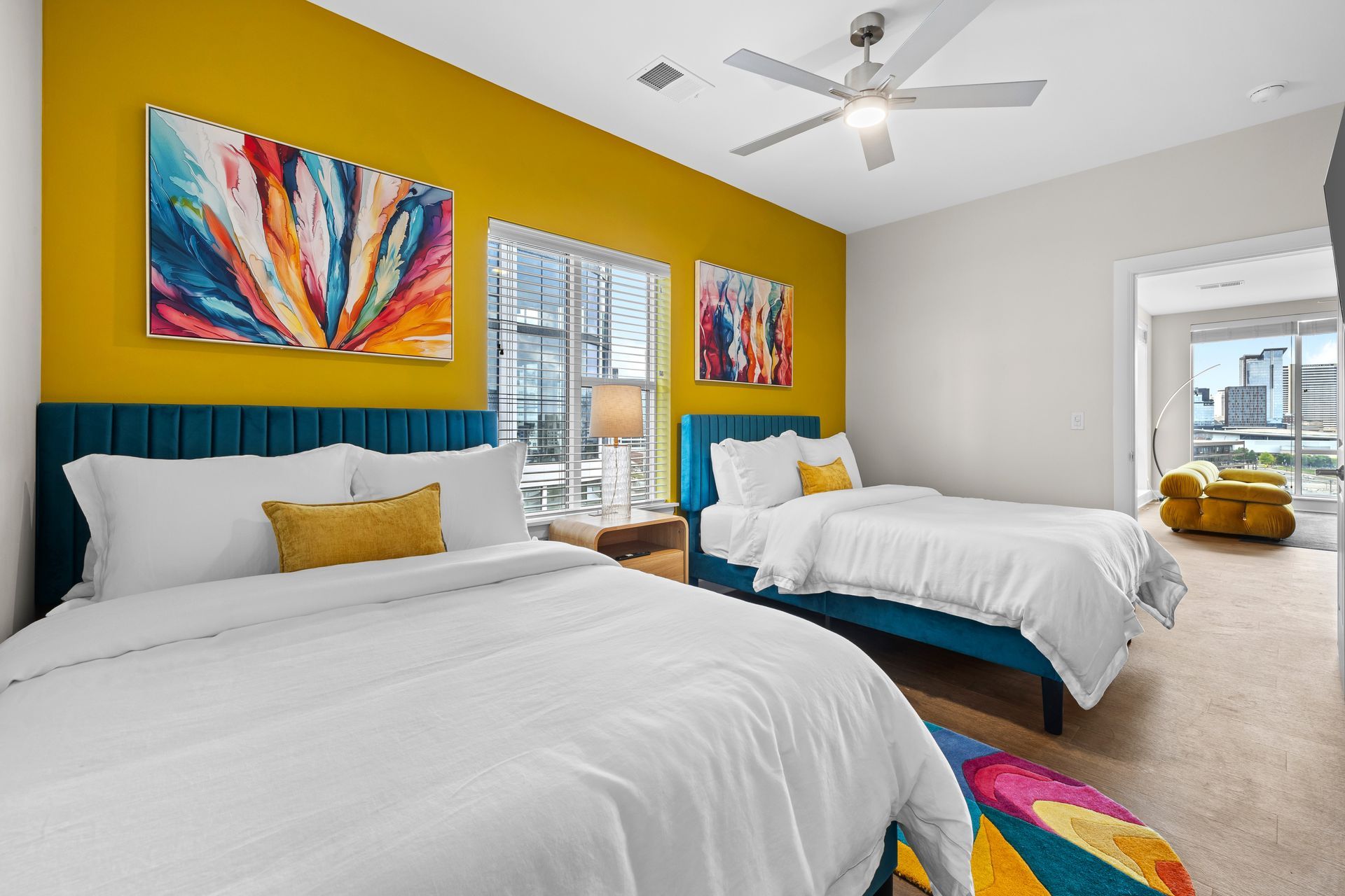 A bedroom with two beds and a ceiling fan.