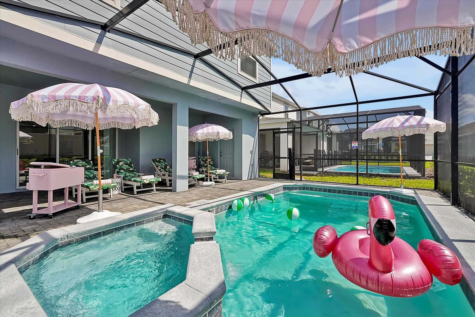 There is a pink flamingo float in the pool.