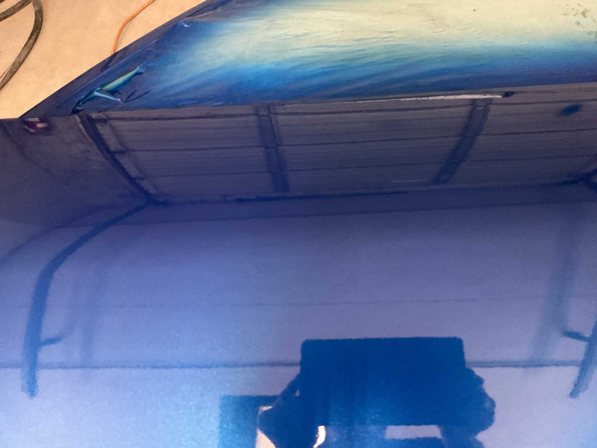 A freshly painted blue car door