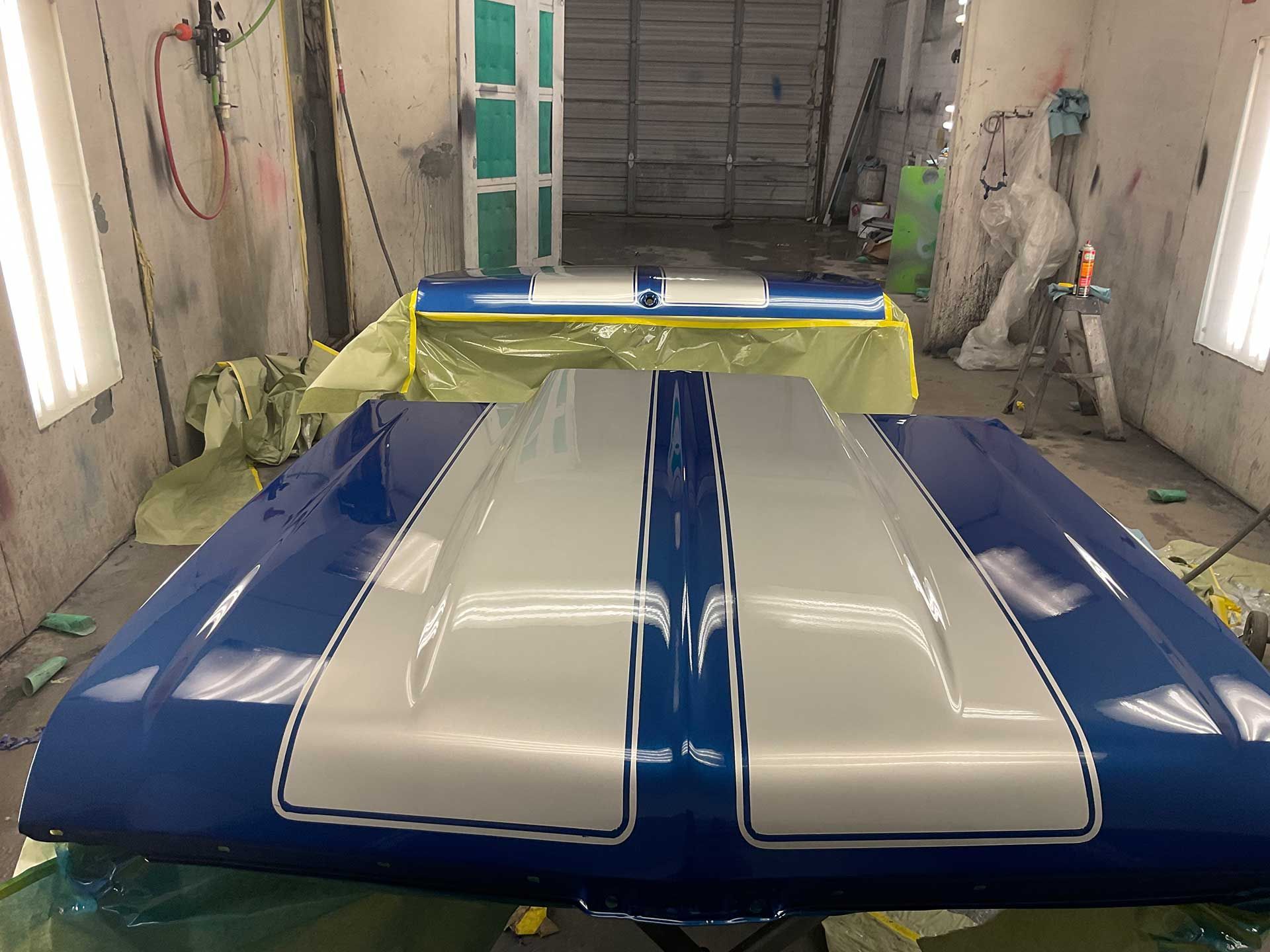 a blue and silver trunk lid and hood