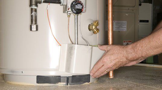 Close up photo of hand repairing the heater