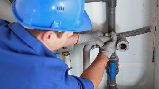 Plumber installing the pipes