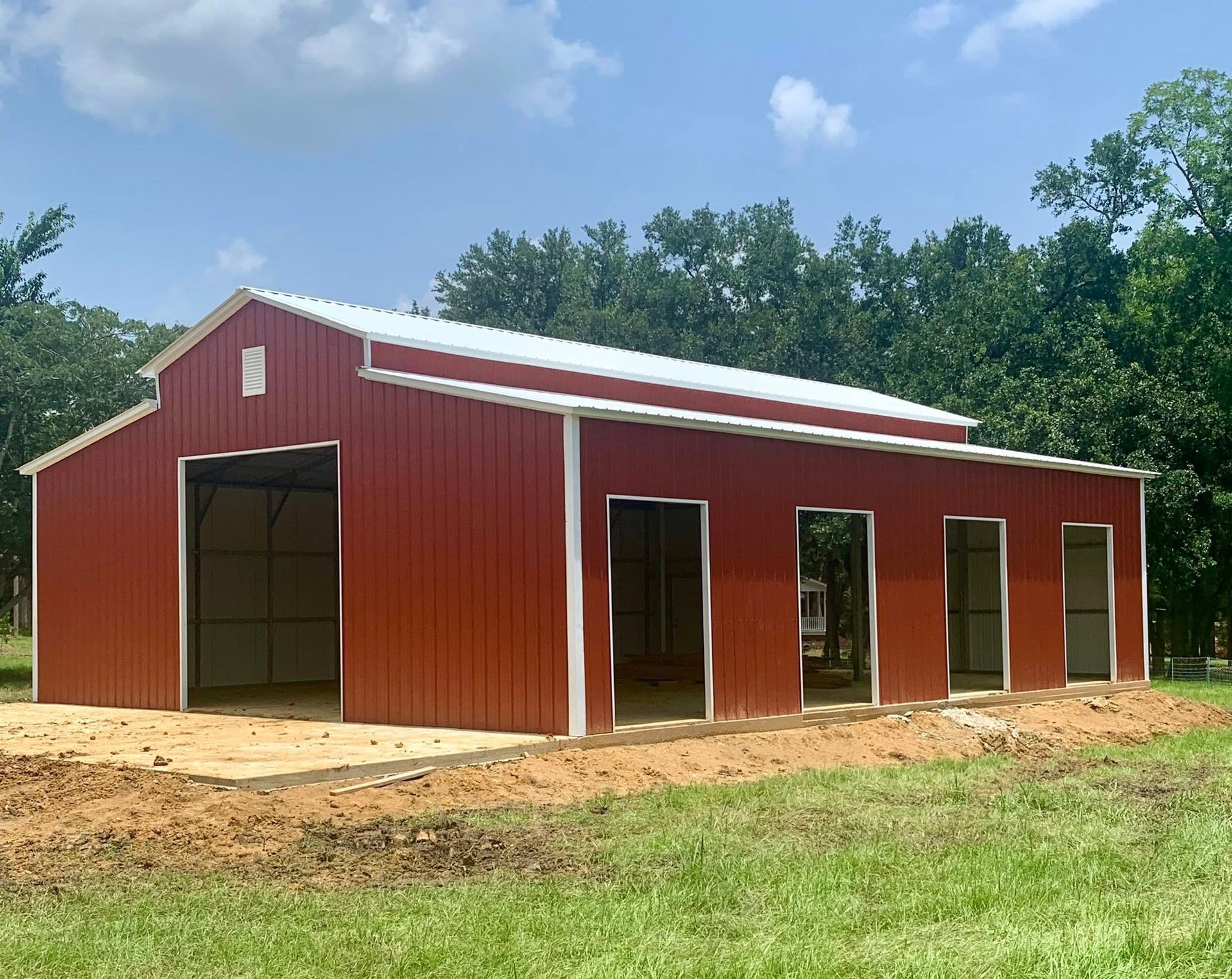 Red metal barn with multiple openings