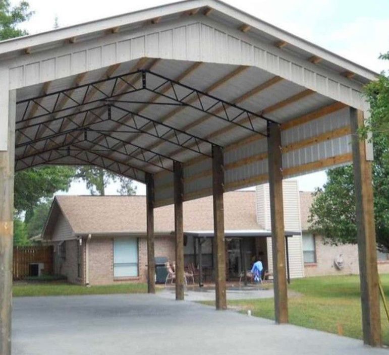 A brick house with a large covered area in front of it