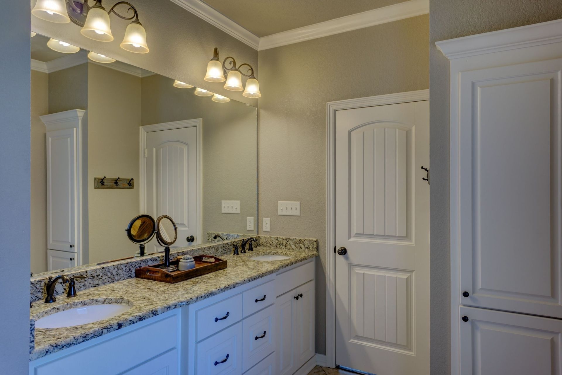 A bathroom with two sinks and a large mirror