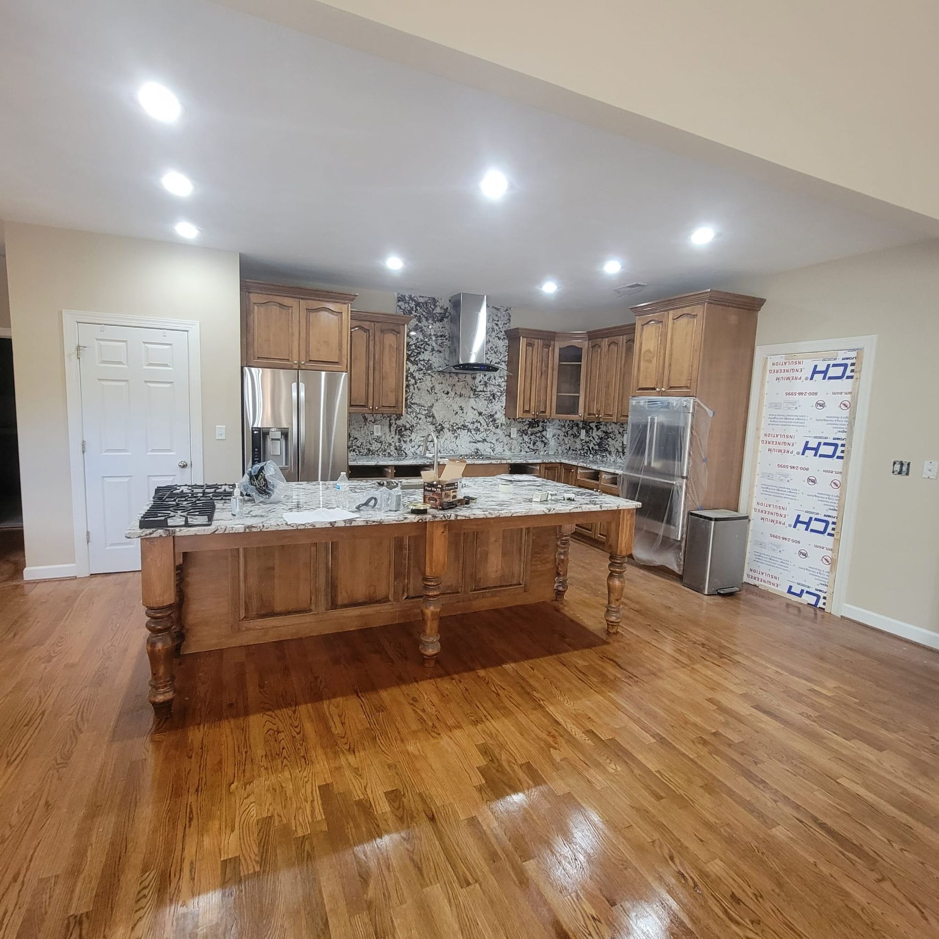 A kitchen with stainless steel appliances and wooden cabinets