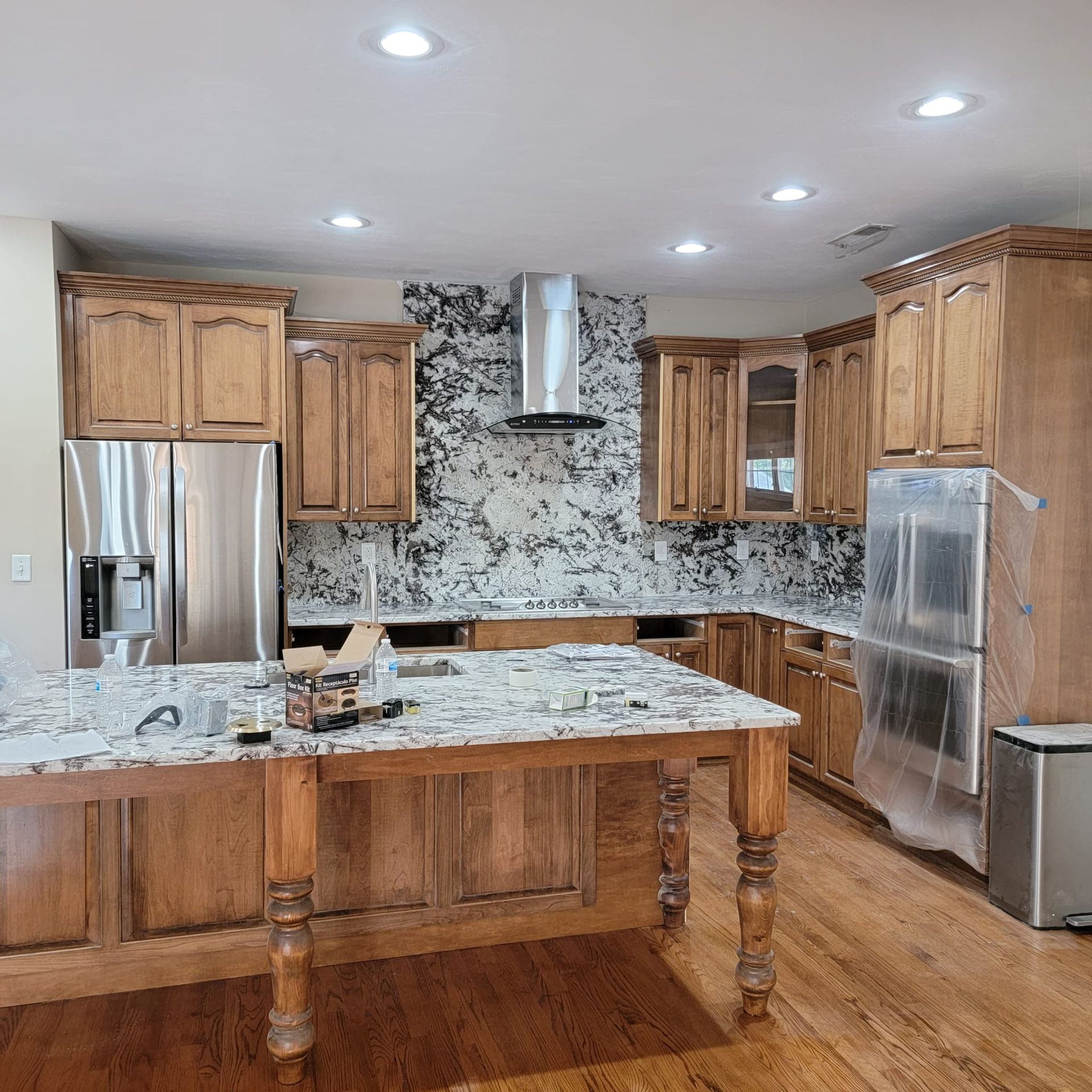 A kitchen with stainless steel appliances and wooden cabinets
