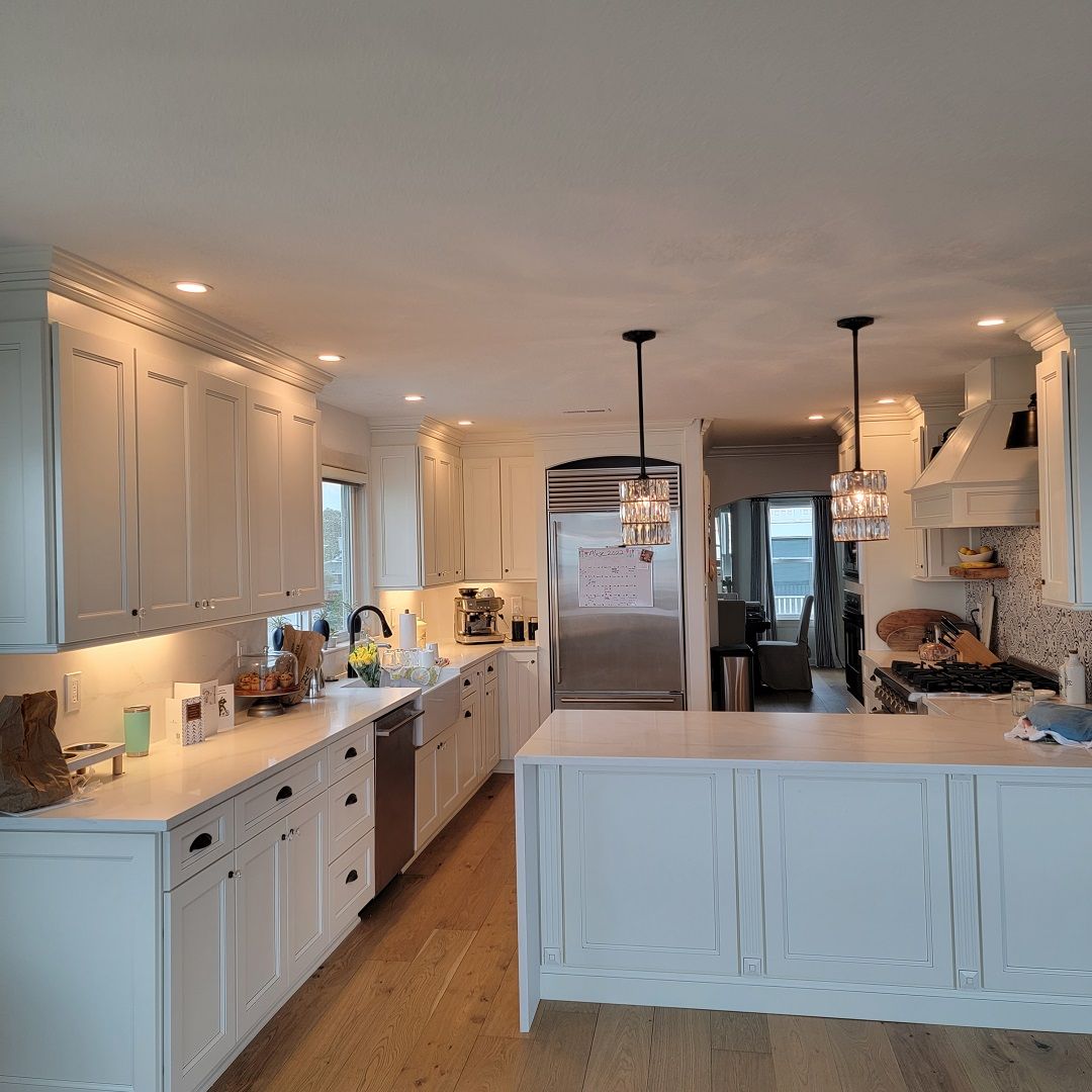 A kitchen with white cabinets and stainless steel appliances