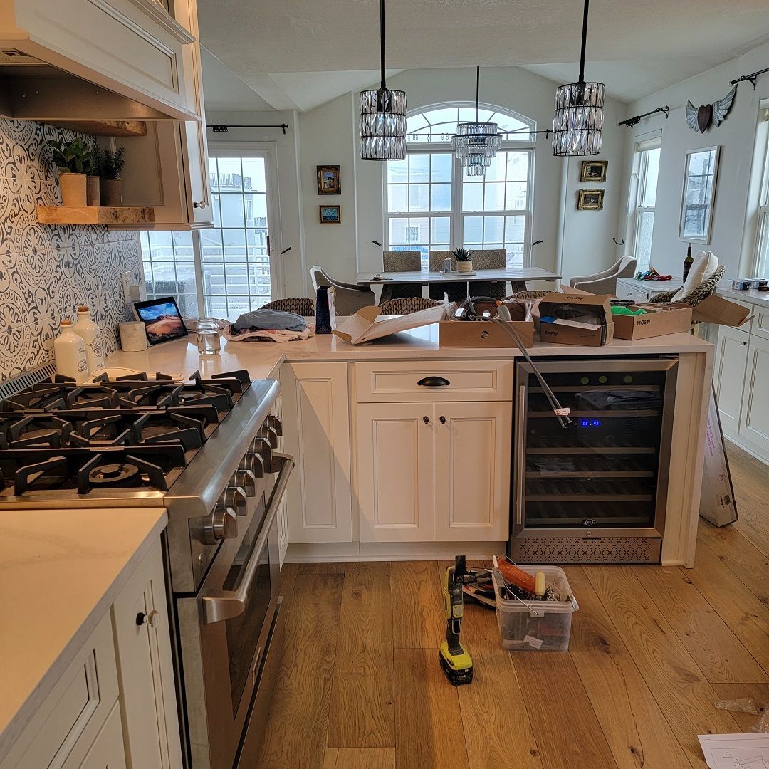 A kitchen with white cabinets a stove and a refrigerator