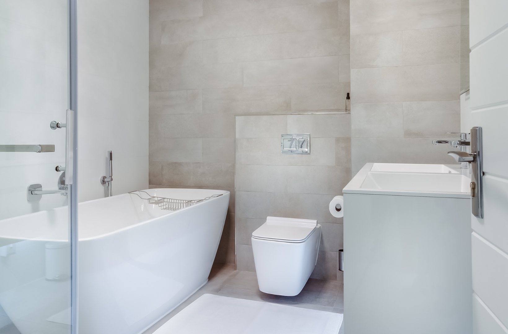 A bathroom with a bathtub, toilet, sink and shower