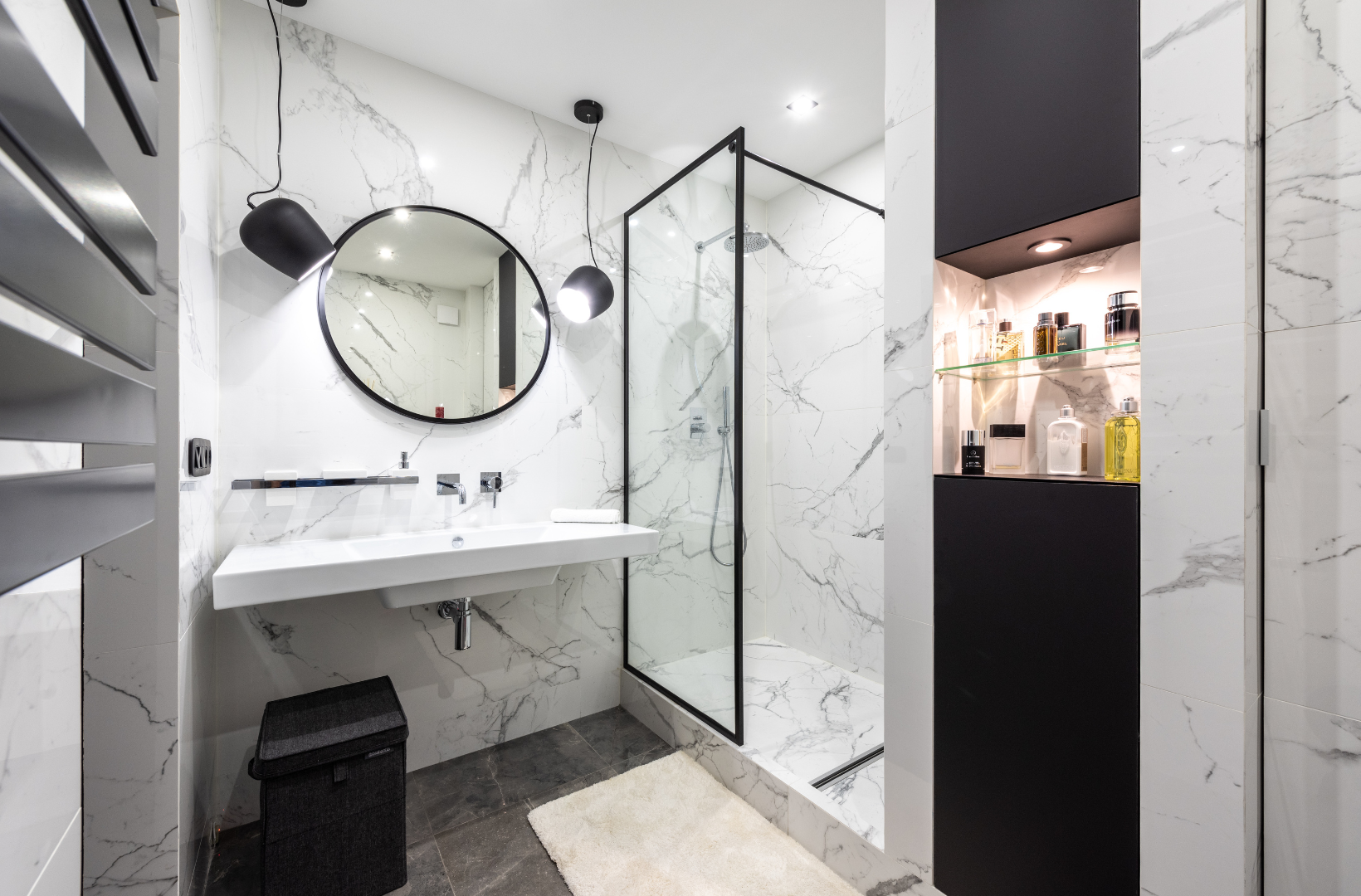 A bathroom with a sink, mirror and walk in shower