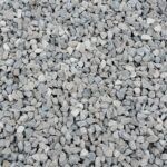 A close-up view of small, light-gray crushed stone gravel.