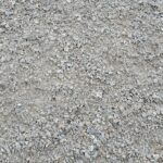 A close-up view of loose, grey gravel and small stone fragments spread across a ground surface.