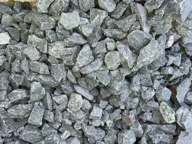 A close-up view of crushed gray angular rocks and gravel stones.