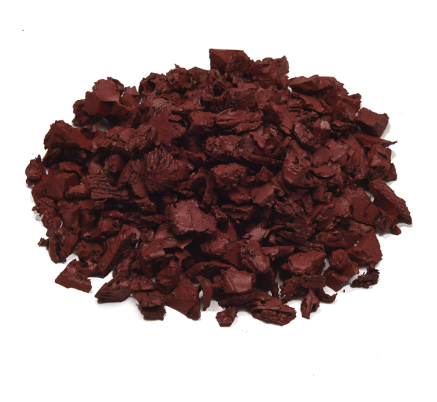 Pile of red rubber mulch on a white background