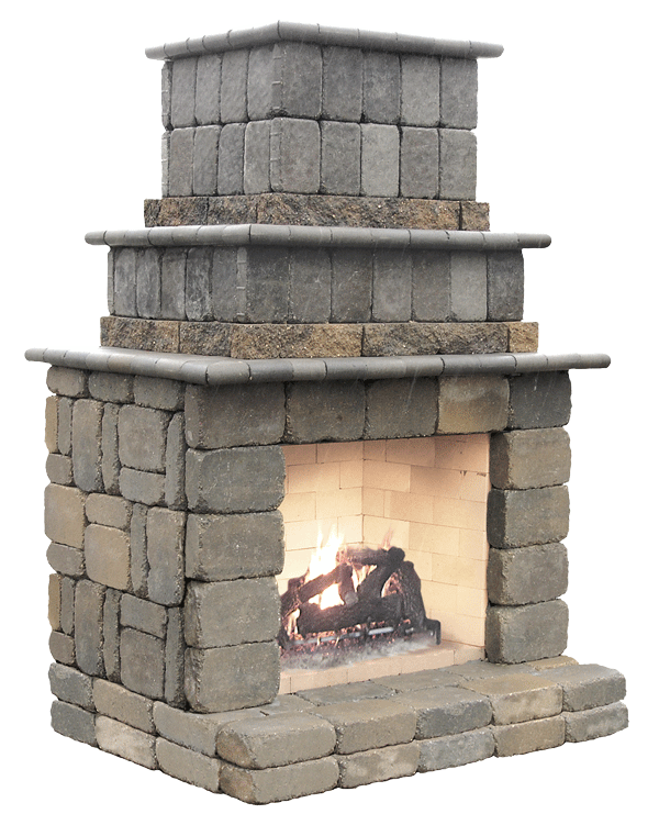 A gray stone outdoor fireplace with a tiered chimney design and a small fire burning in the hearth.
