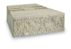 A single light gray concrete retaining wall block with a textured, rugged front face.