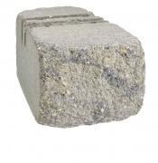 A grey, rectangular concrete retaining wall block with a textured, rock-like front face and a grooved top surface.