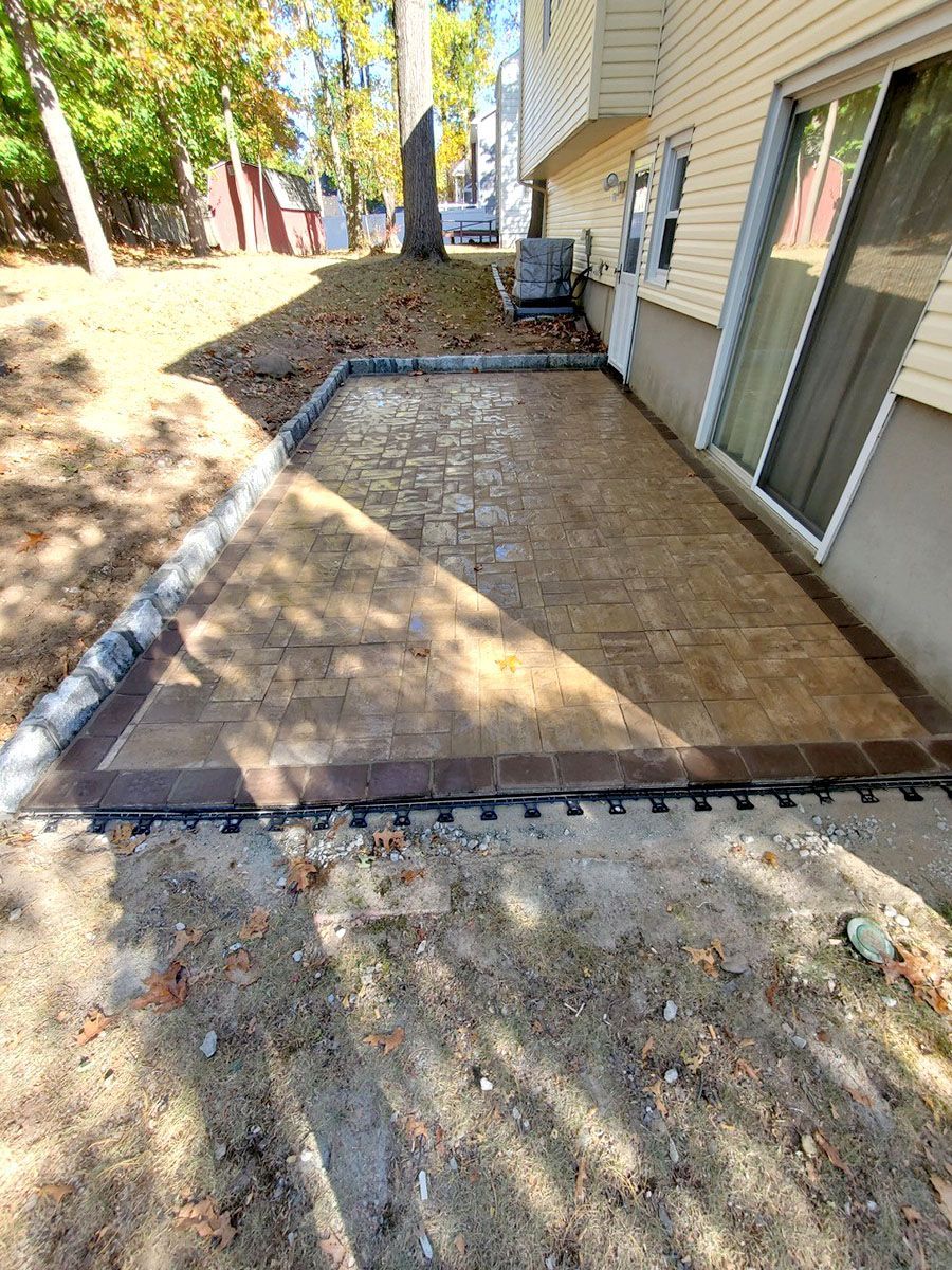 A newly built patio in the backyard of a house