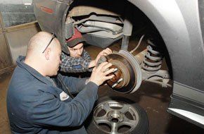 Mechanics are repairing car brake