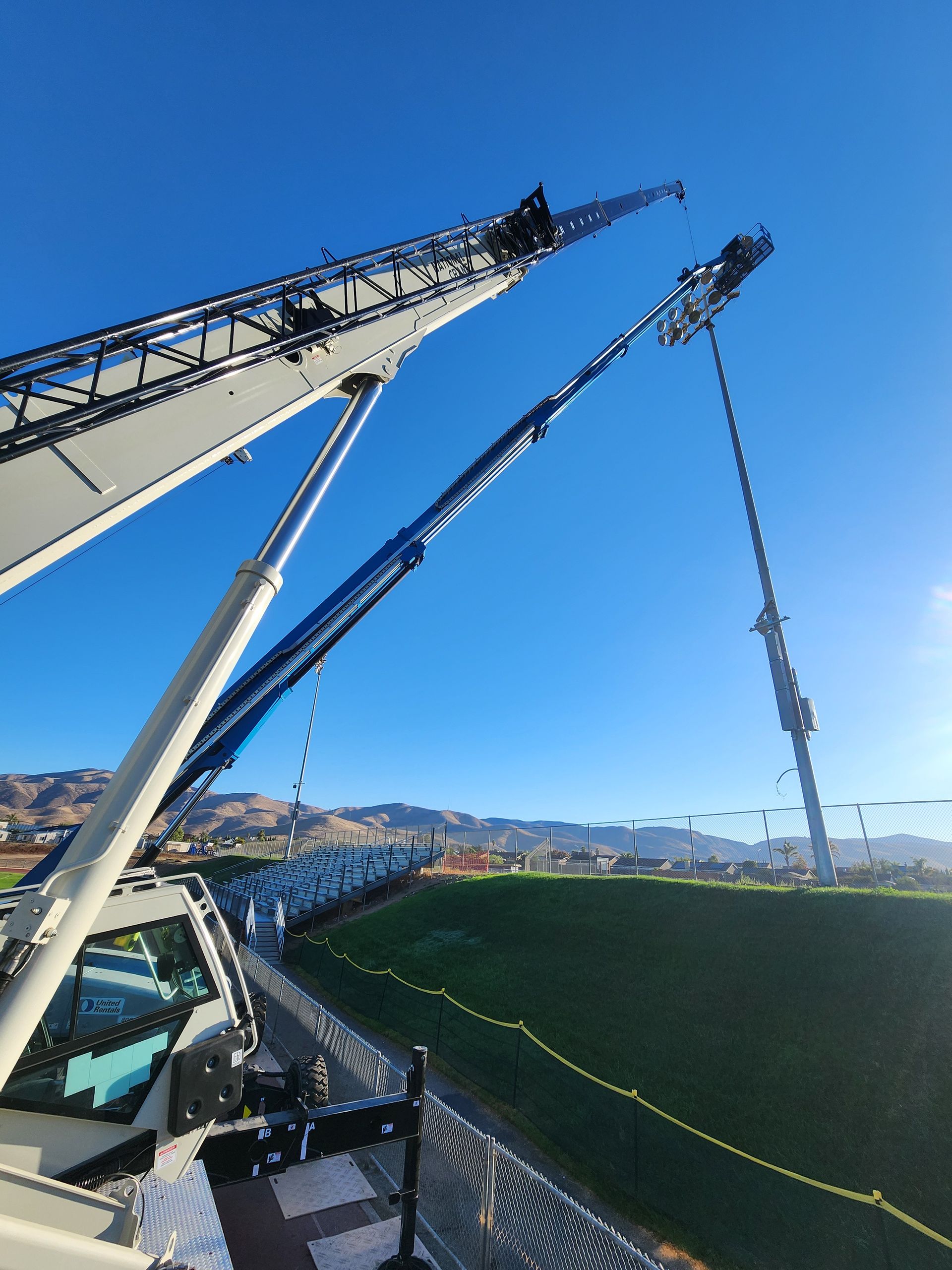 A large crane is sitting on top of a stadium