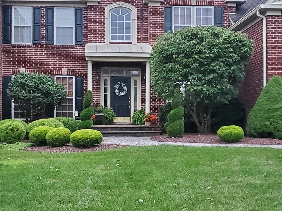 A large brick house with a wreath on the front door