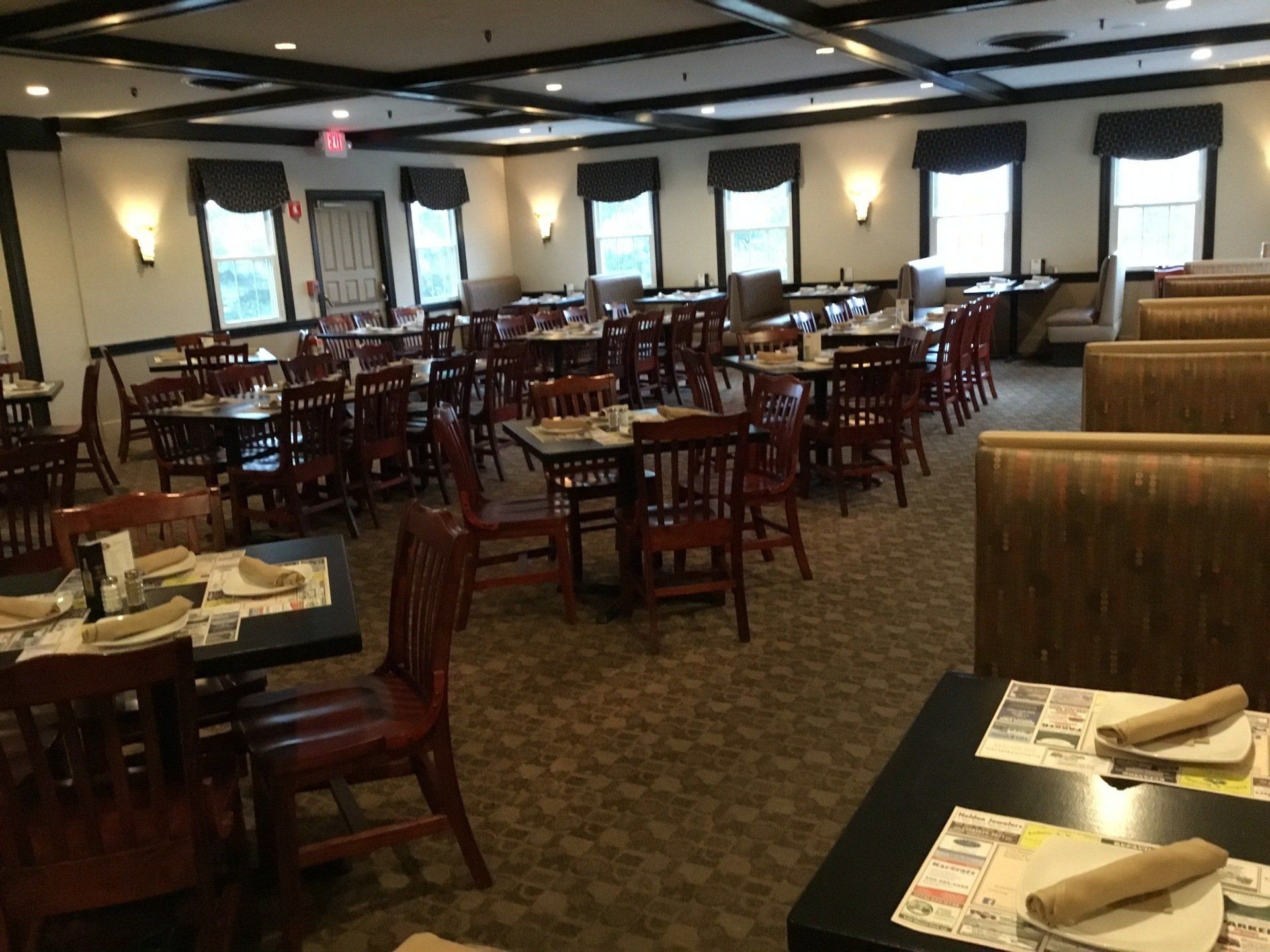 A restaurant with tables and chairs and a lot of windows