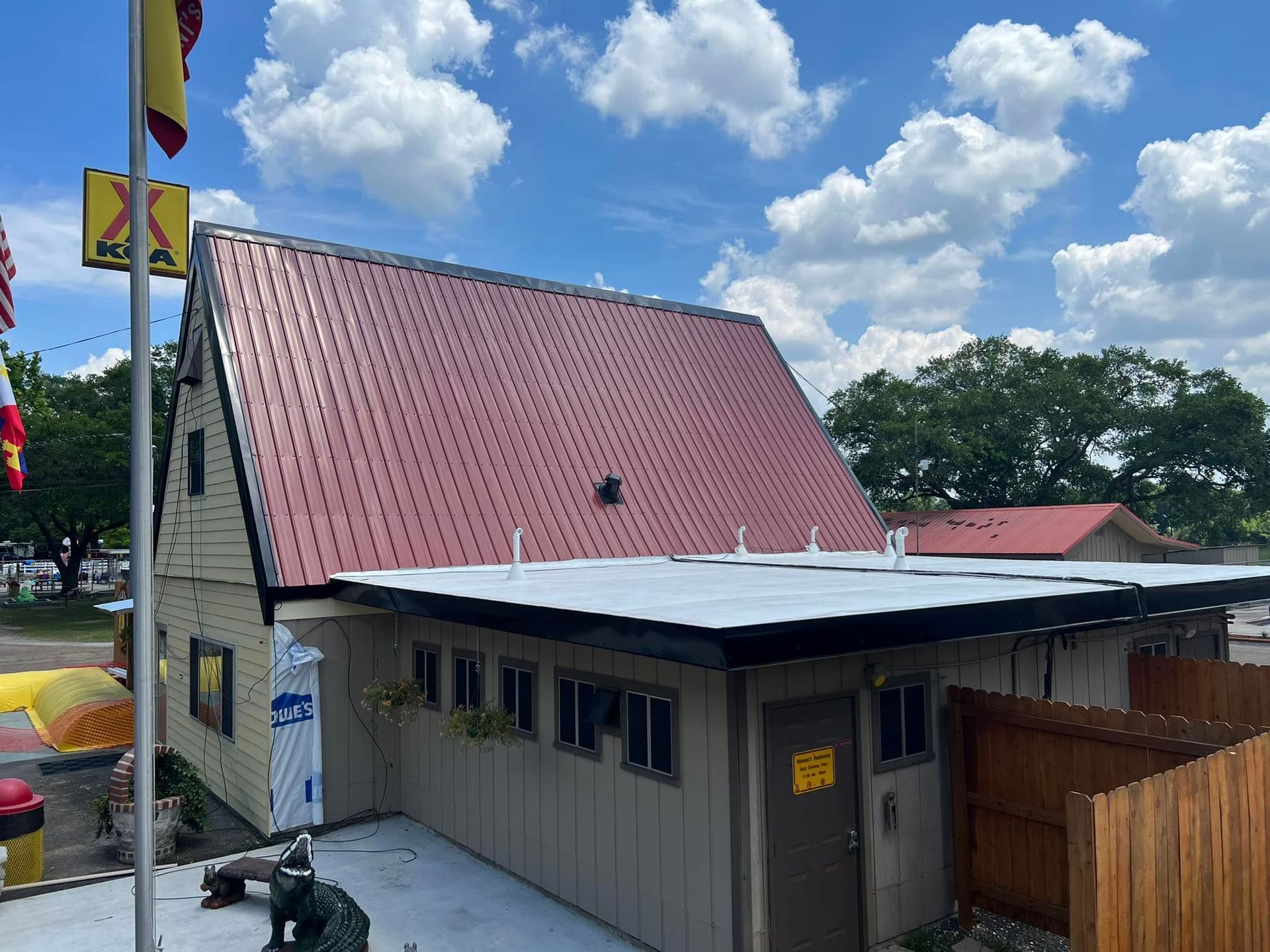 A building with a red roof and a yellow flag on top of it.