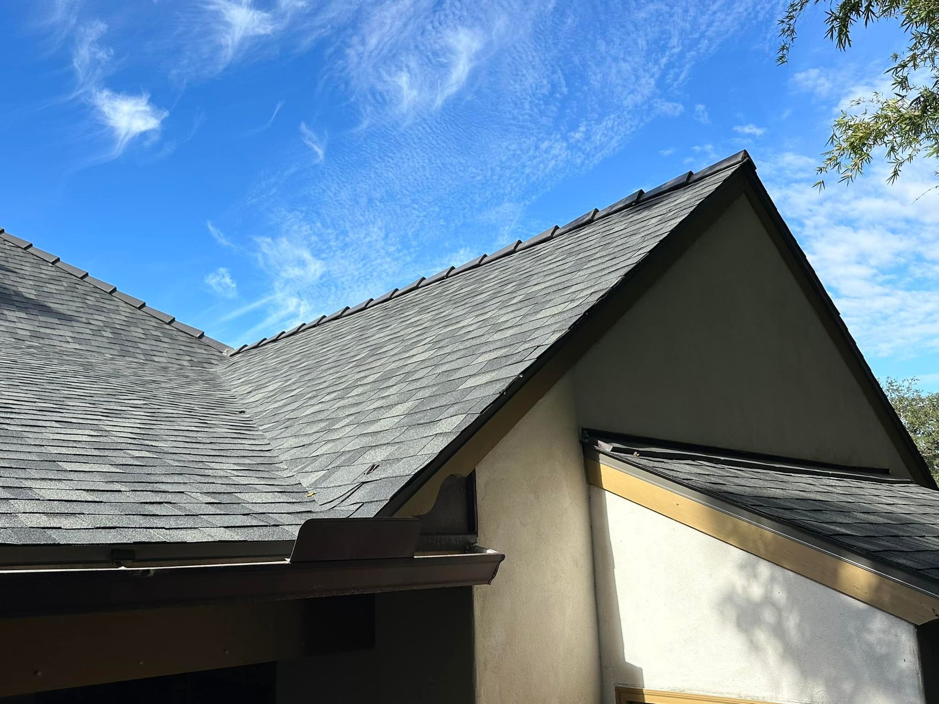 A roof of a house with a blue sky in the background