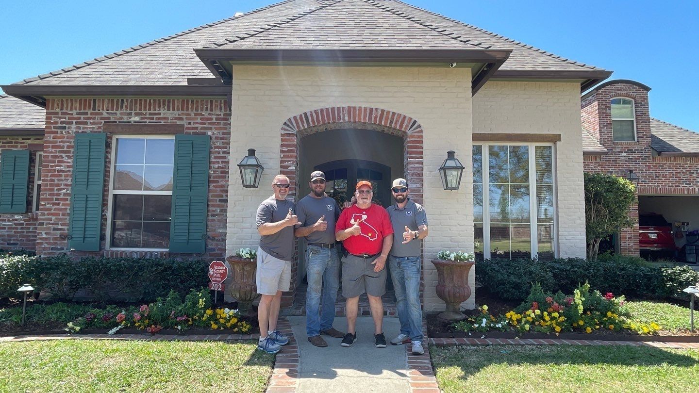 A group of men are standing in front of a house.
