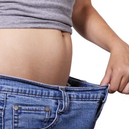 Person with loose jeans, showing weight loss.