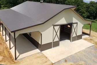 An aerial view of a large metal barn with sliding doors.