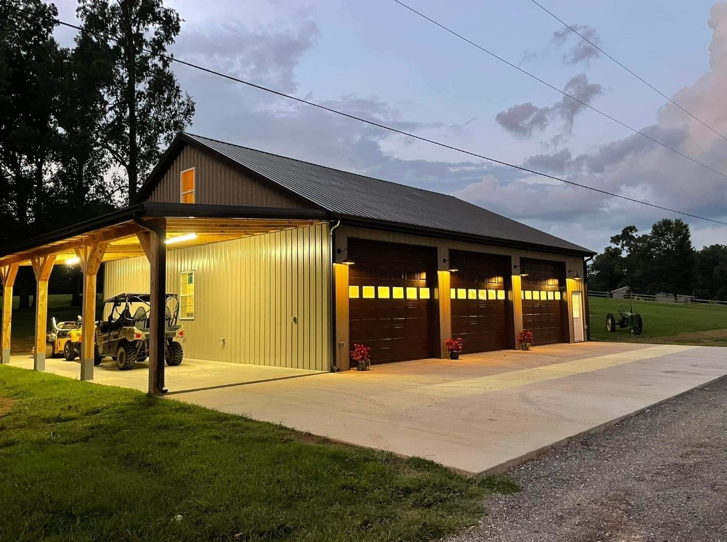A garage with four garage doors and a covered driveway.