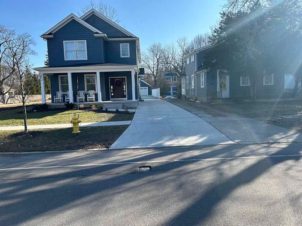 A blue house with a fire hydrant in front of it.