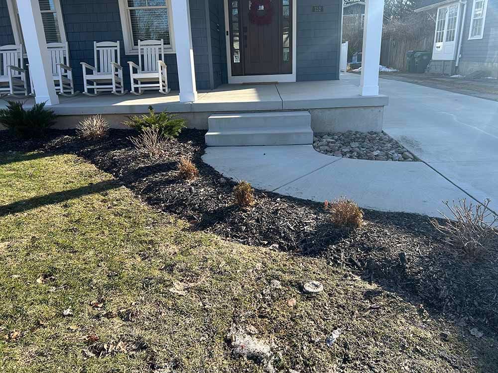 There are rocking chairs on the porch of a house.