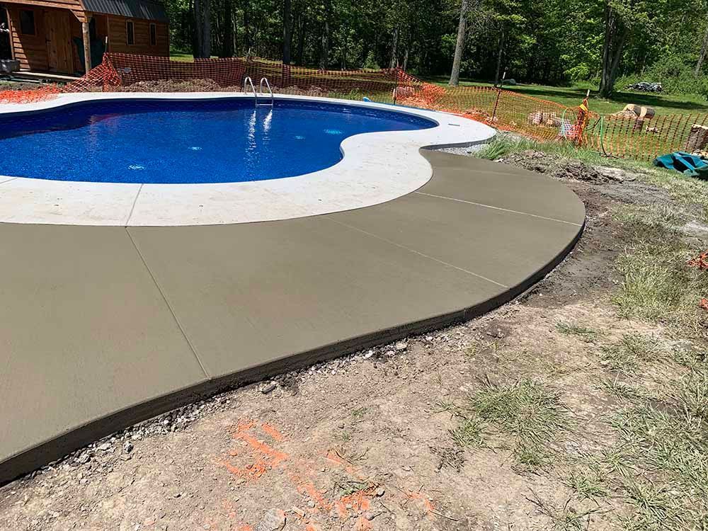 A large swimming pool is being built in a backyard.