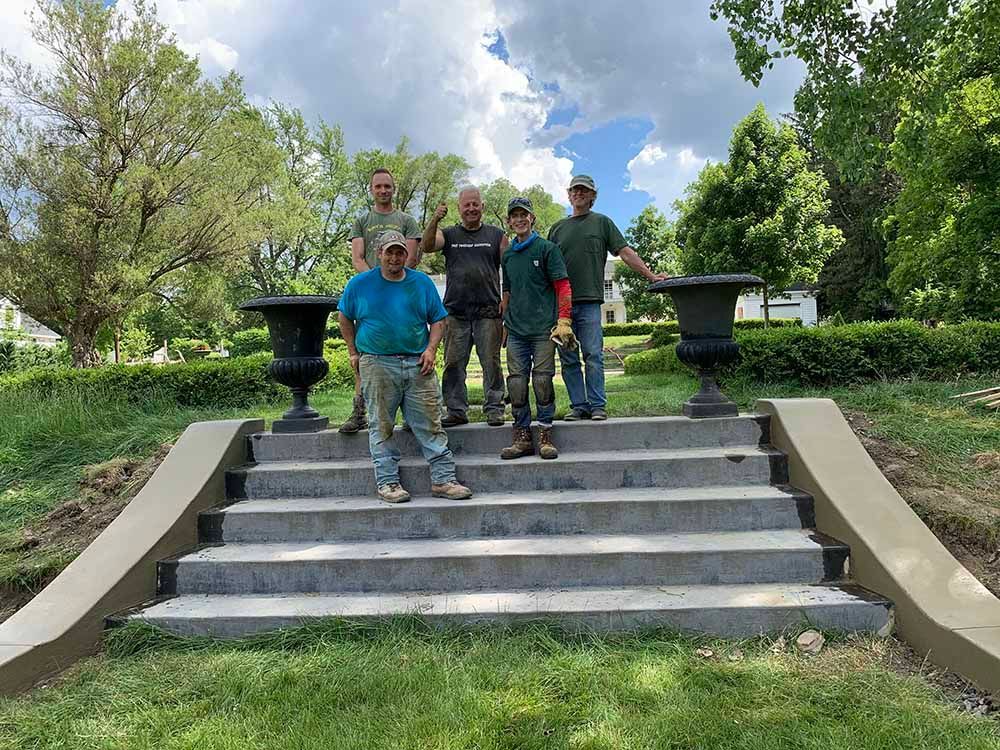 A group of men are standing on top of a set of stairs.