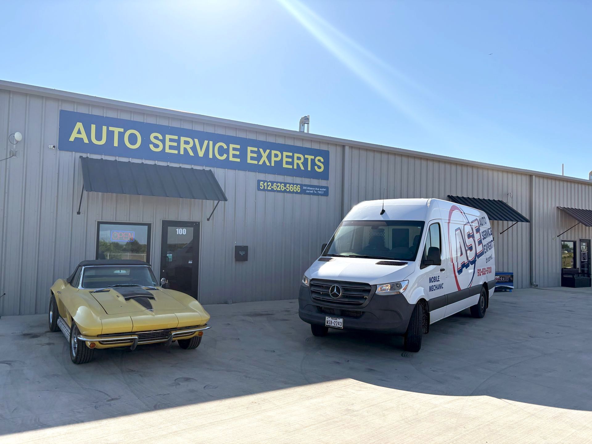 Auto Service Experts' building exterior with a yellow car and company vehicle parked in front
